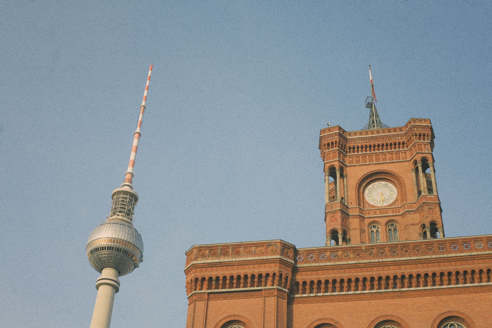 View of the Berlin TV Tower and Rotes Rathaus under a clear blue sky.