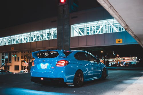 Modern sports car on road near building at dusk