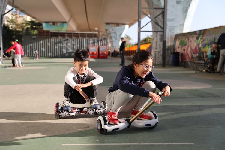 Children Riding  Hoverboard On The Park