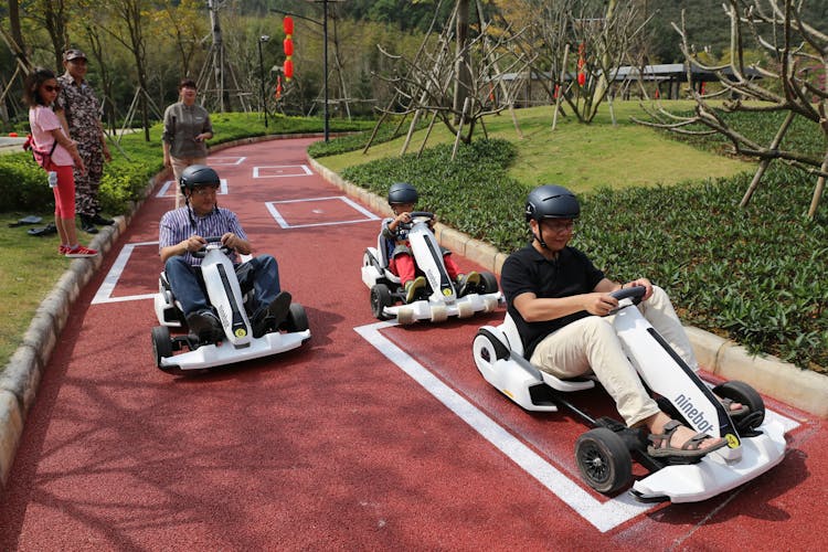 People Driving Go Karts On Race Track