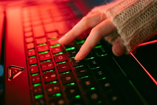 Free A Person Typing on a Keyboard Stock Photo