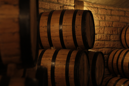 Casks heaped together in an underground cellar — photo by Jonathan Nenemann on Pexels
