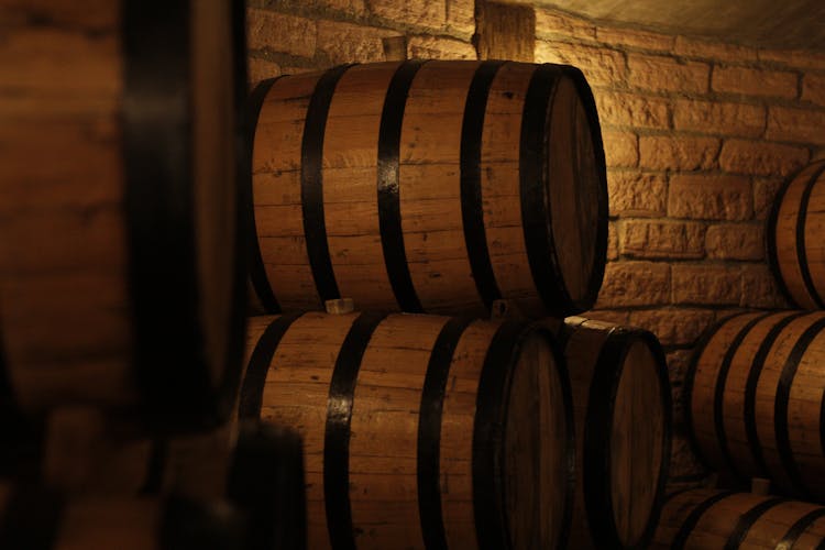 Wooden Barrels With Wine In Cellar