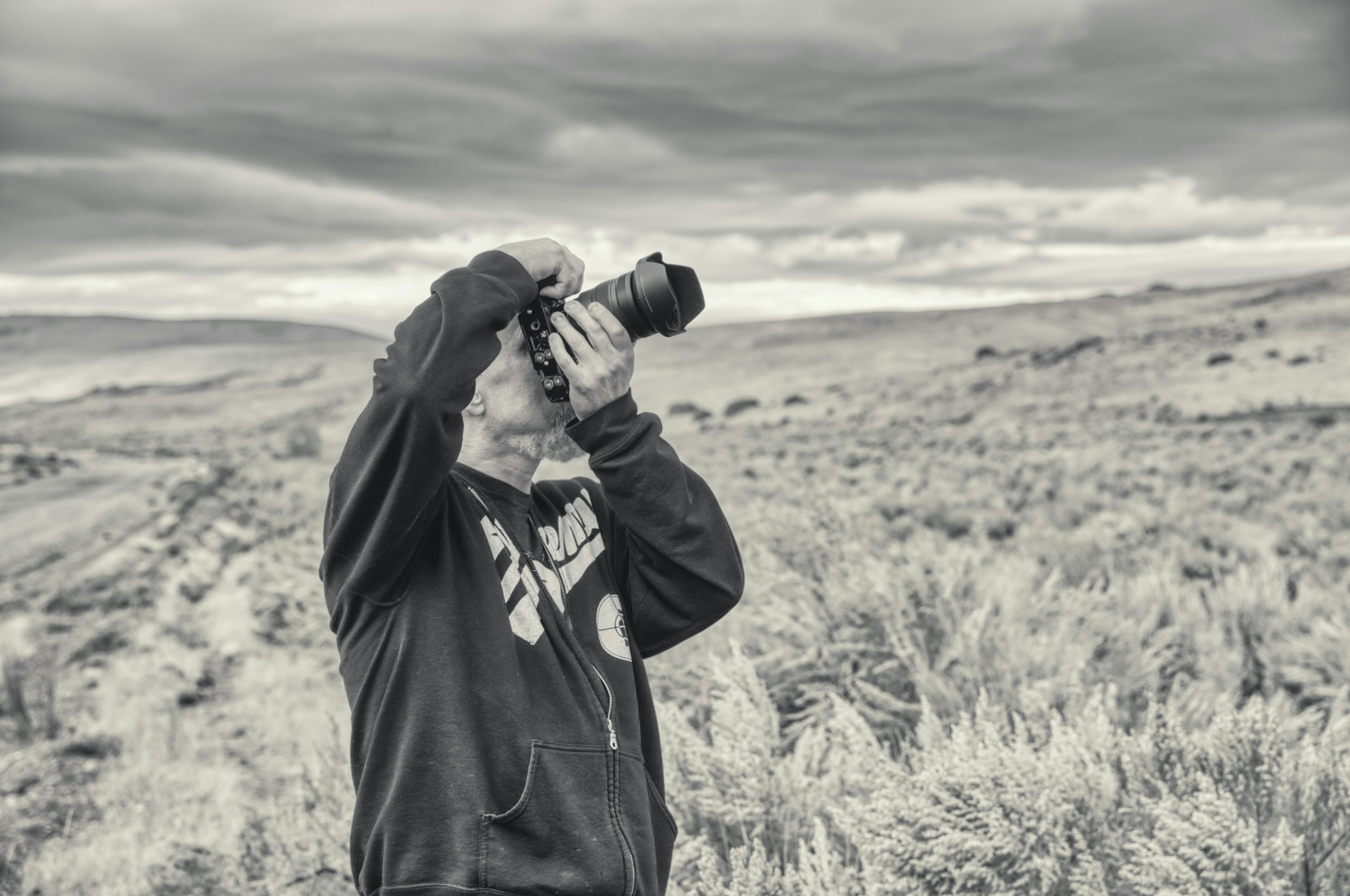 Grayscale Photo of a Man Taking Photo · Free Stock Photo