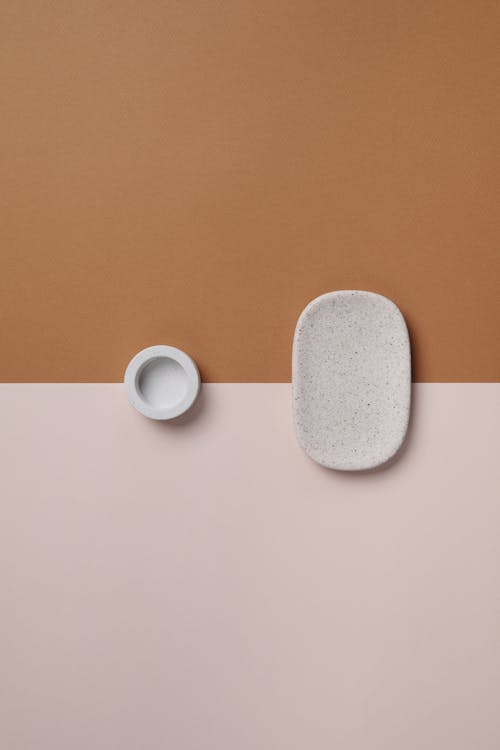 Abstract Photograph of Simple Holders against a Beige Background