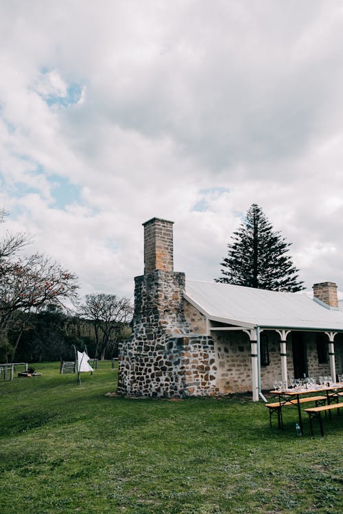 Free Small shabby house on grassy lawn Stock Photo