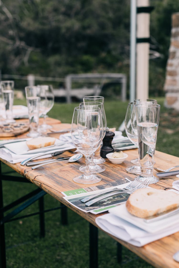 Banquet Table With Dishware In Backyard