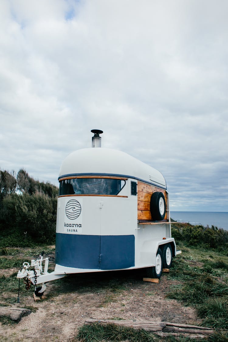 White Trailer On Grassy Embankment