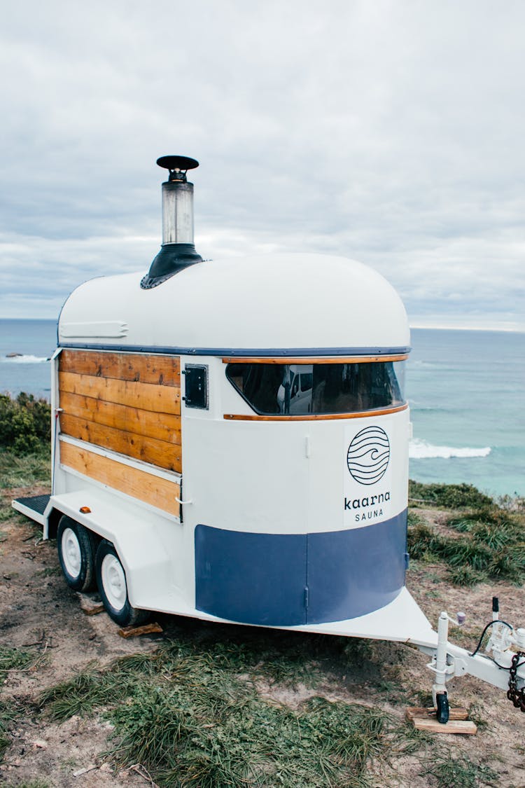 White Trailer On Grassy Shore