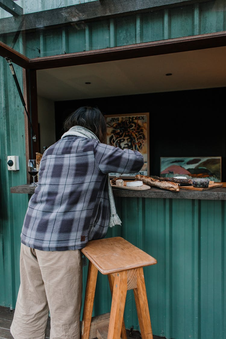 Unrecognizable Person Cutting Cheese At Stall