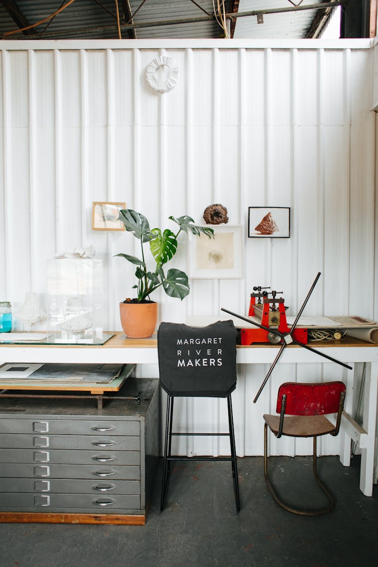 Chair Near Table In Studio With Manufactured Bag