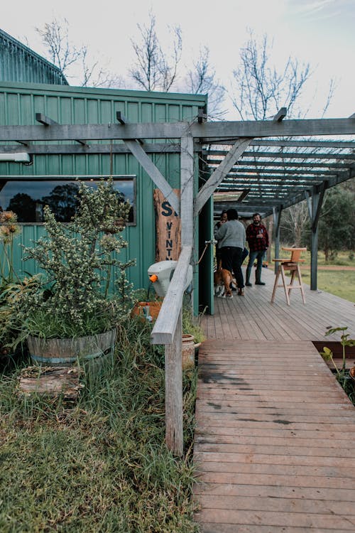 People on wooden terrace of house