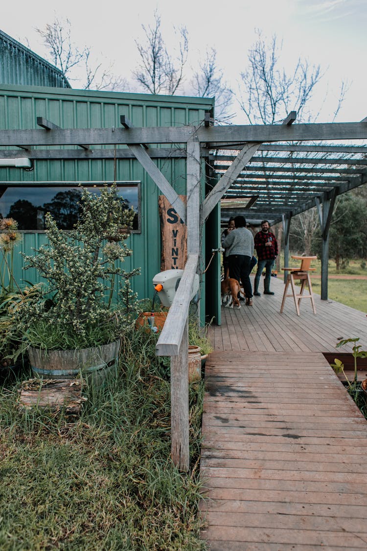 People On Wooden Terrace Of House