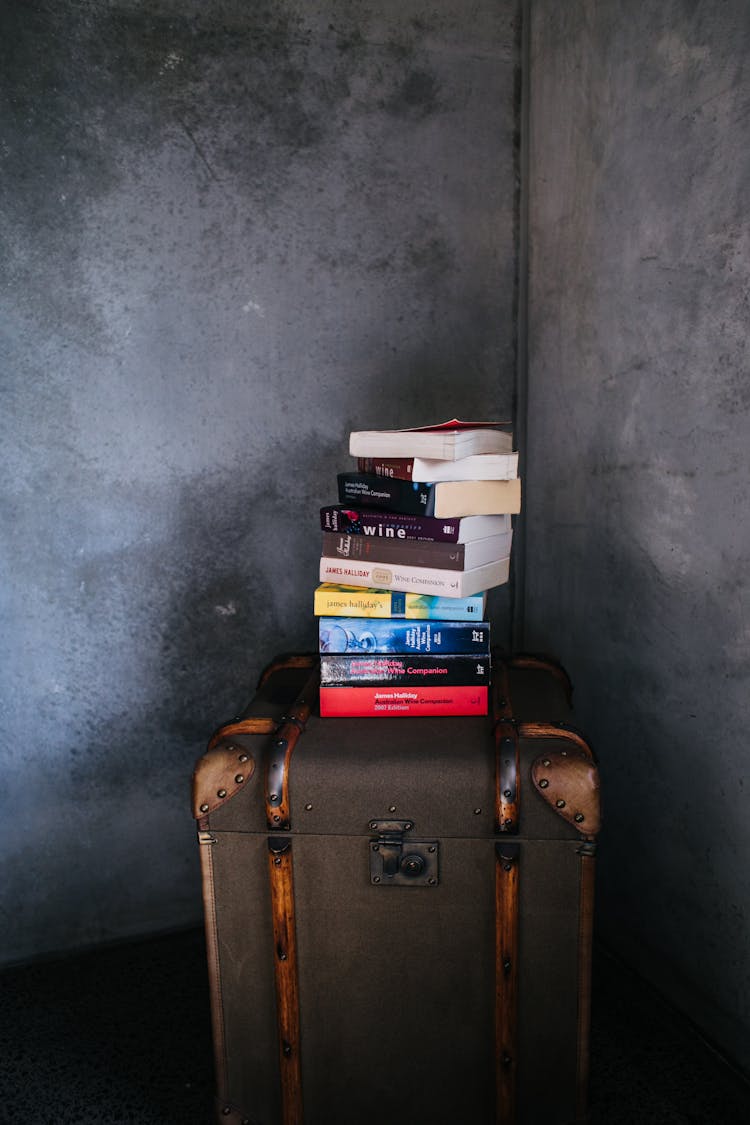 Stack Of Books Placed On Top Of A Luggage