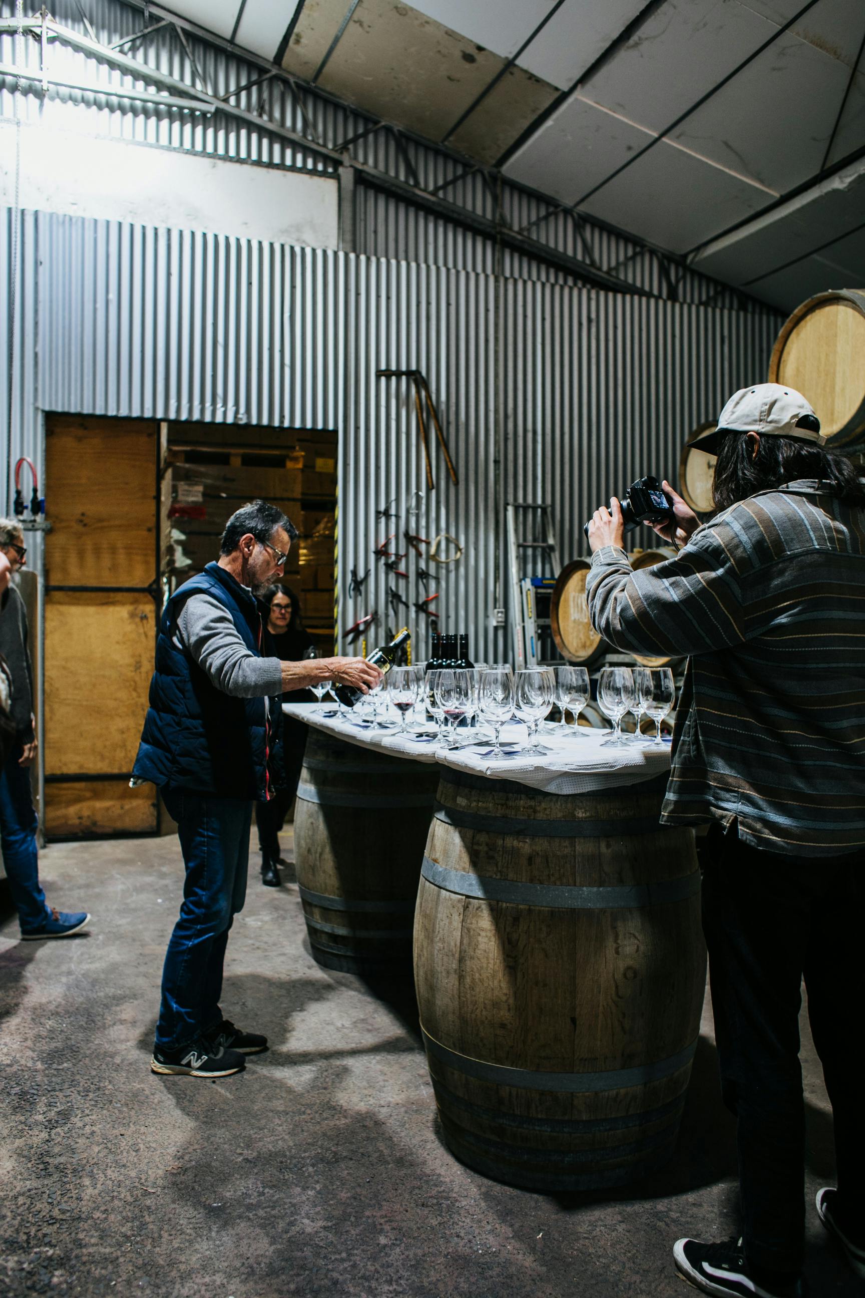 sommelier pouring wine in winery
