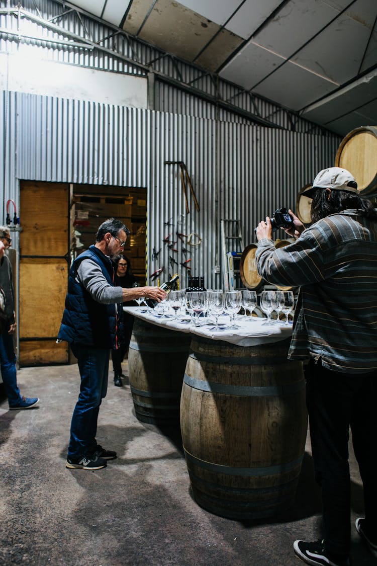 Sommelier Pouring Wine In Winery