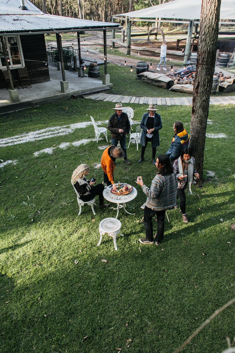 Unrecognizable People Having Picnic On Backyard