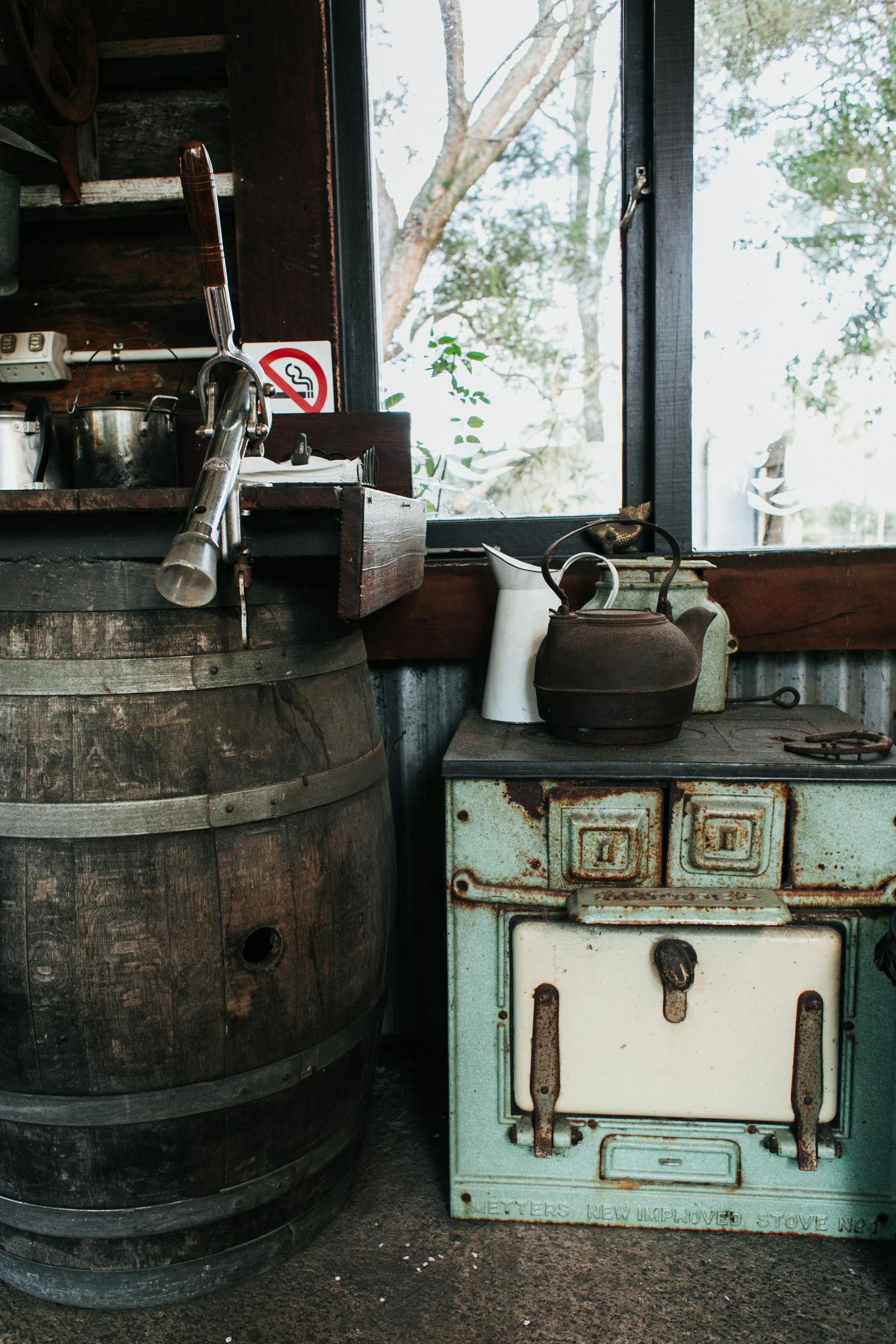 old stove near wooden barrel