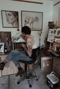 Skilled man drawing on canvas