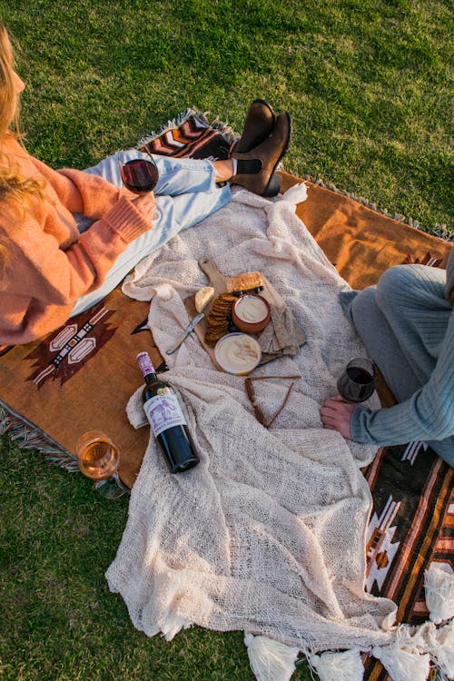 Free Crop women having picnic on blanket Stock Photo
