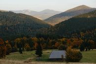 小屋坐落在充满活力的森林山谷中，迷人的秋季山景