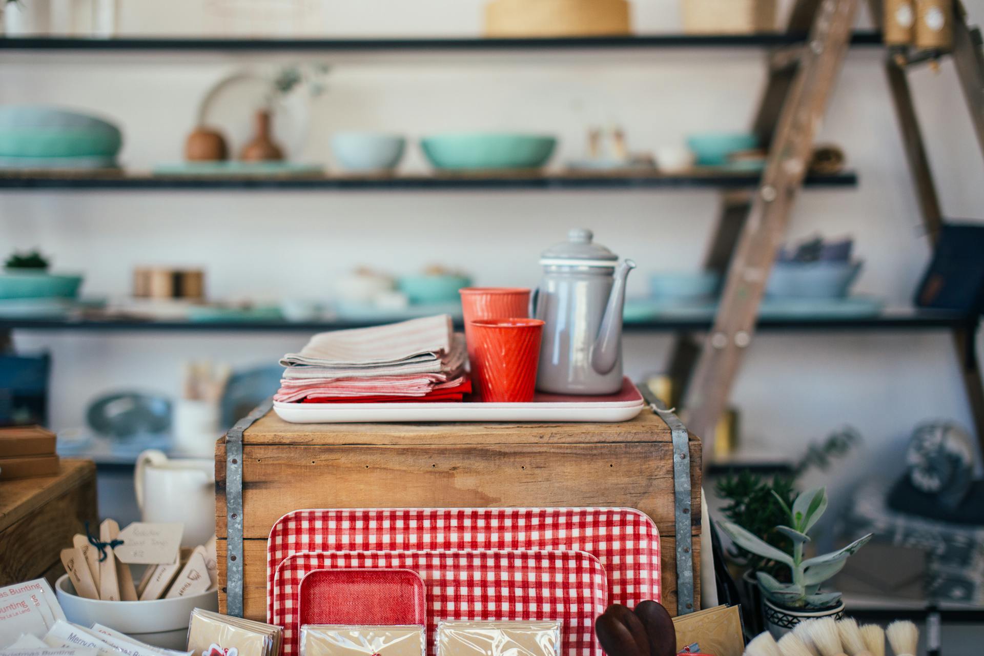 Kettle with plastic cups prepared on wooden box