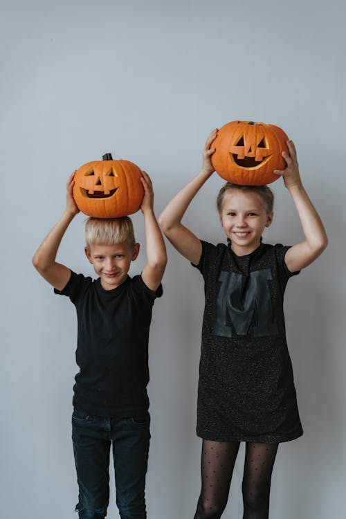 Boy and Girl Holding Jack O Lantern