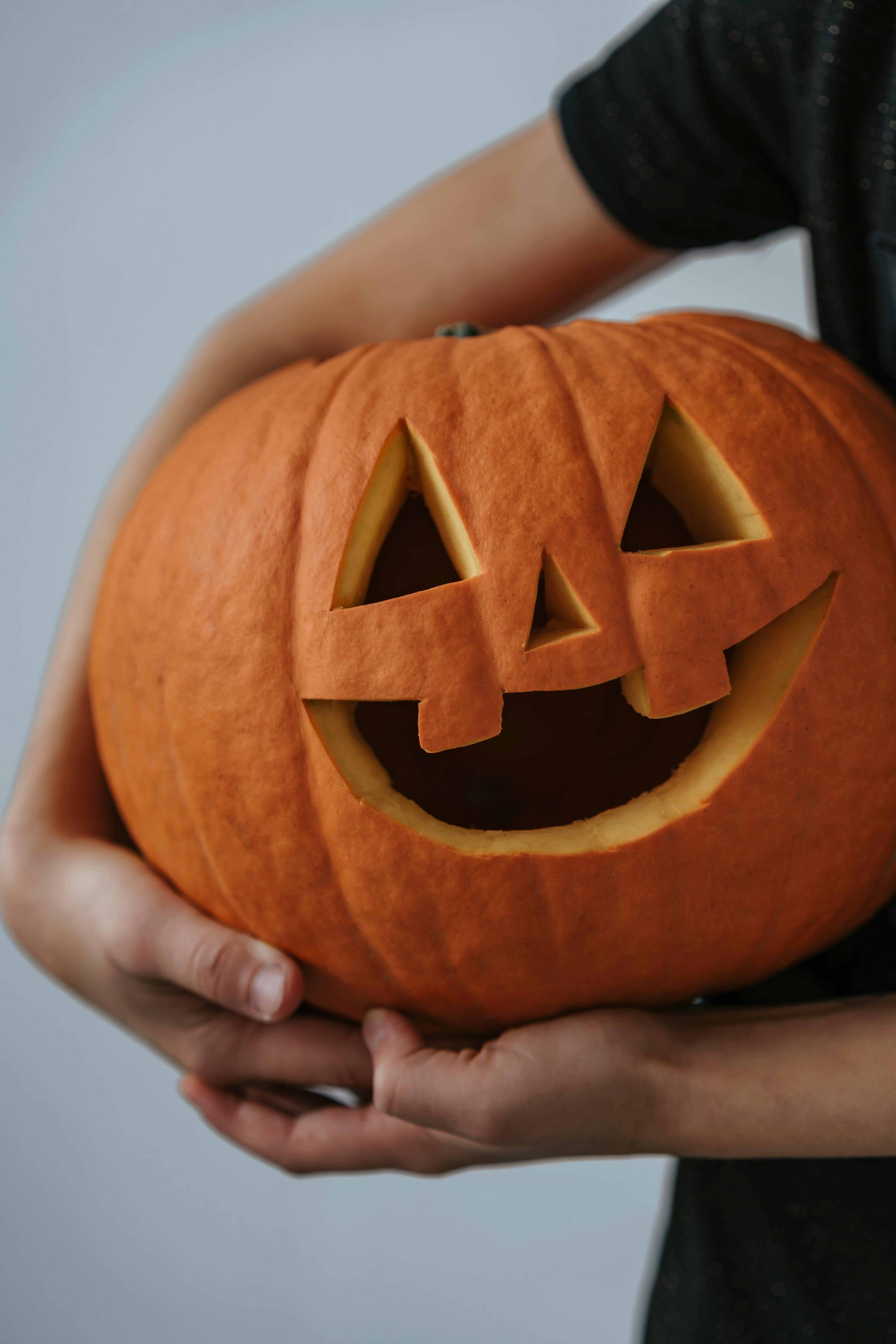 Hands Carrying a Jack O Lantern · Free Stock Photo