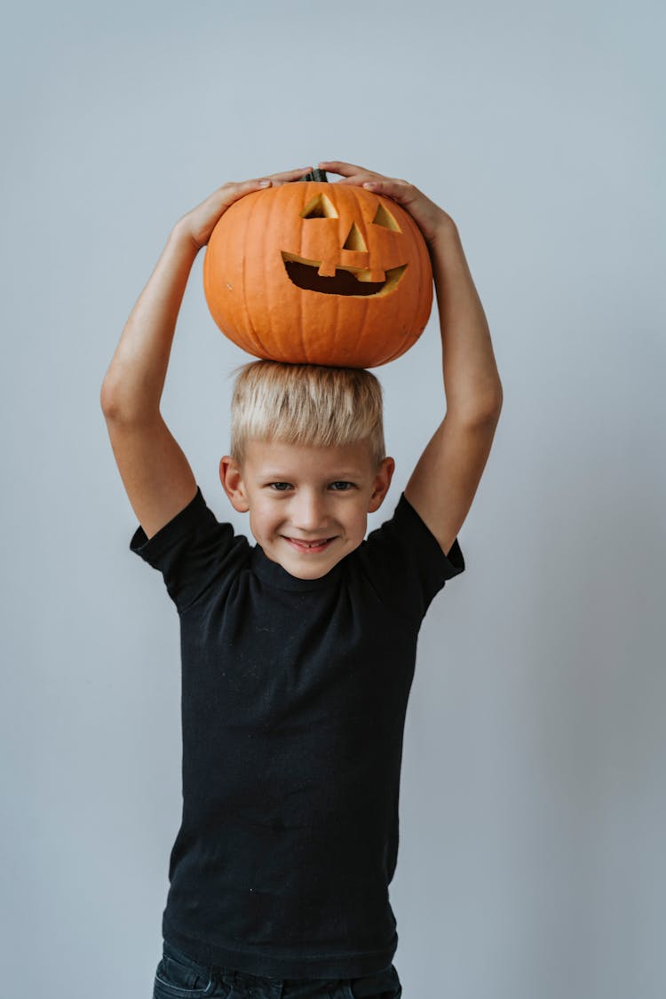 Boy Holding Jack O Lantern