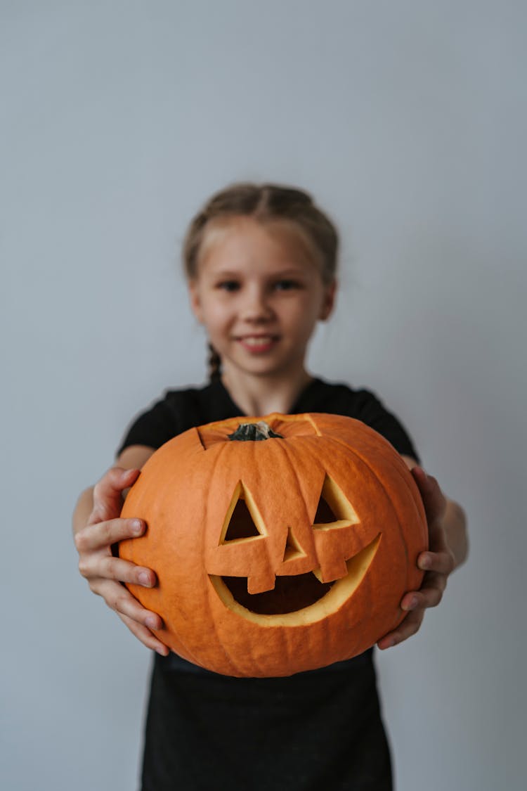 Girl Holding A Jack O Lantern