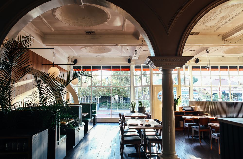Spacious classy restaurant interior with arches in daylight