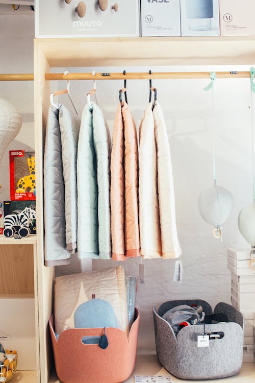 Collection of soft towels and sponges hanging on rack in wardrobe in in modern modern store