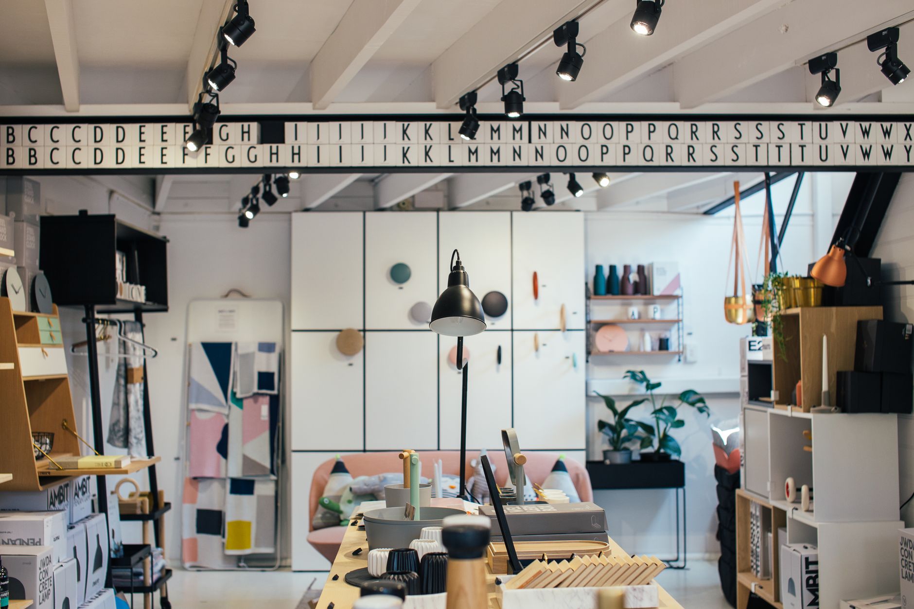 Home goods sit on open wooden shelving, the kind of display that makes a cheap errand feel curated.