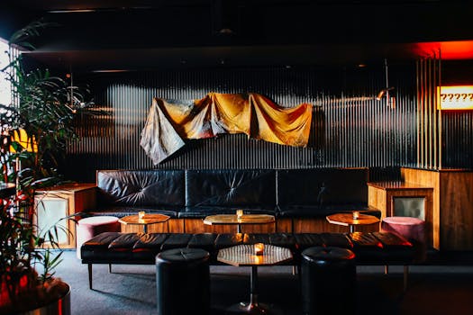 Interior of contemporary restaurant with stylish dark furniture and black walls in daylight