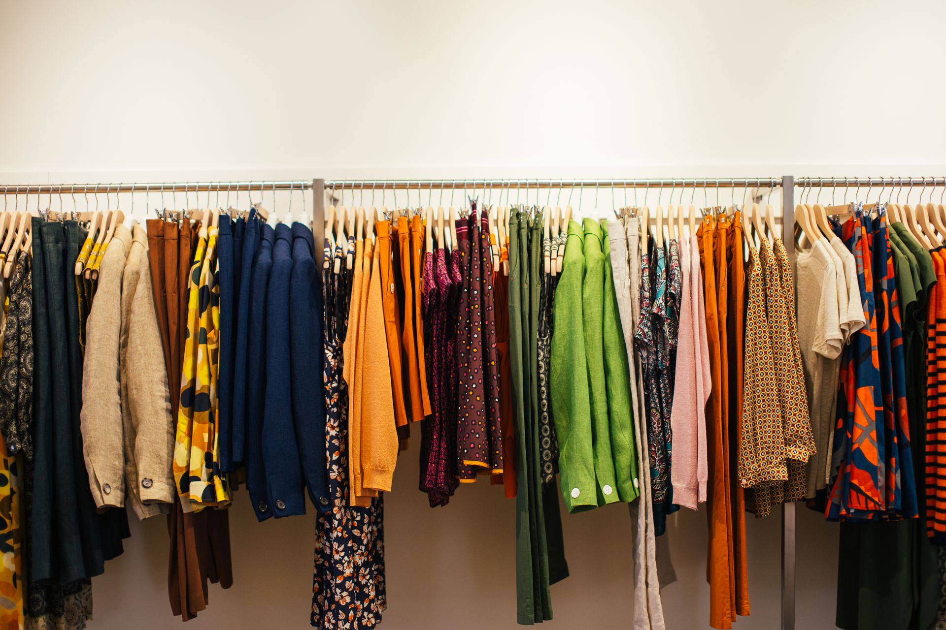 Multicolored clothes hanging on rack