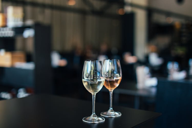 Glasses With Alcoholic Drinks On Table In Restaurant