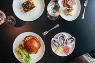 Plates with burger and pie neat crackers and mussels