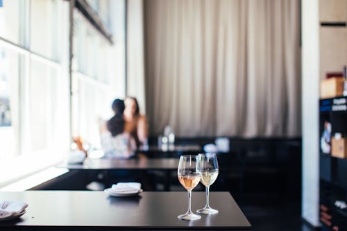 Free Wineglasses with wine on table in cafe Stock Photo