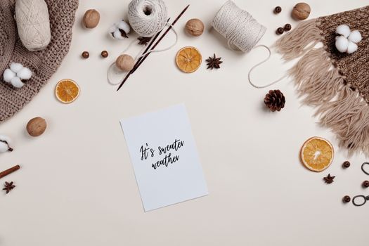 A flat lay with knitting supplies and autumn decorations, perfect for cozy fall creativity.