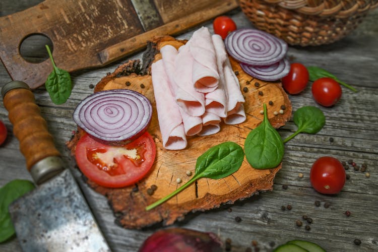 Ham And Sliced Onions On Brown Wooden Chopping Board