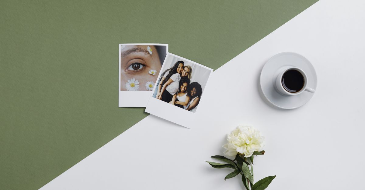 Modern flat lay featuring black coffee, Polaroid photos, and a white flower on a minimalistic backdrop.