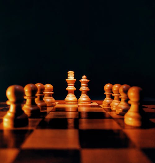 Free Brown Chess Pieces on Brown Wooden Chess Board Stock Photo