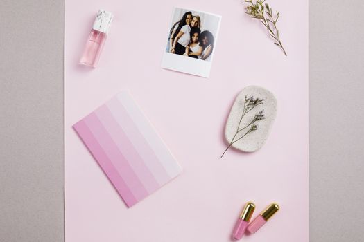 Feminine flat lay featuring cosmetics, a polaroid photo, and pink-themed items on a pastel background.. pexels, feminine, fla