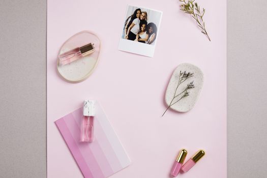 Stylish flat lay featuring pink-hued perfumes, floral decor, and a casual photograph on a soft pink backdrop.. pexels, stylis