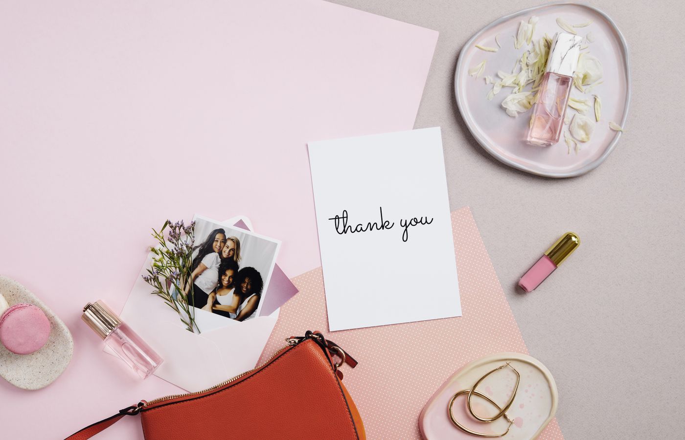 Aesthetic flat lay of accessories and a thank you card with pink tones, perfect for a feminine theme.