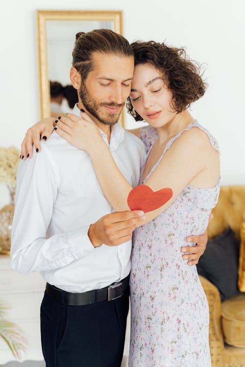 Woman in Floral Dress Hugging a Man