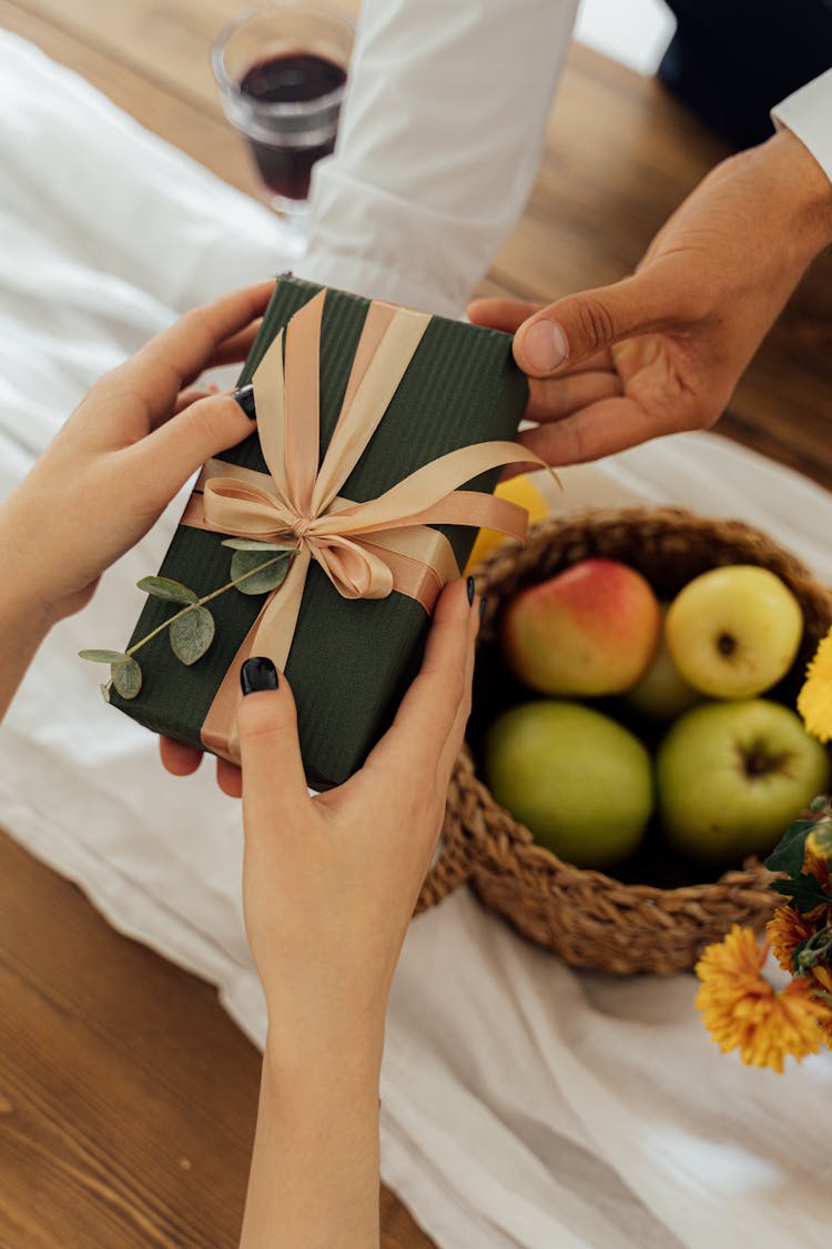 Person Holding A Gift Box