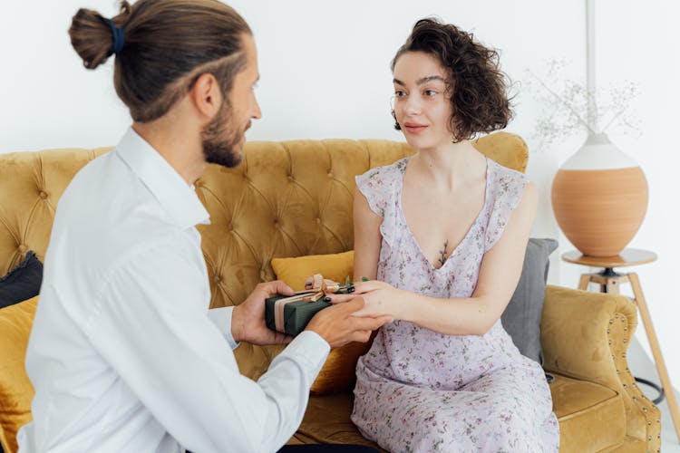 A Man Giving A Present To A Woman