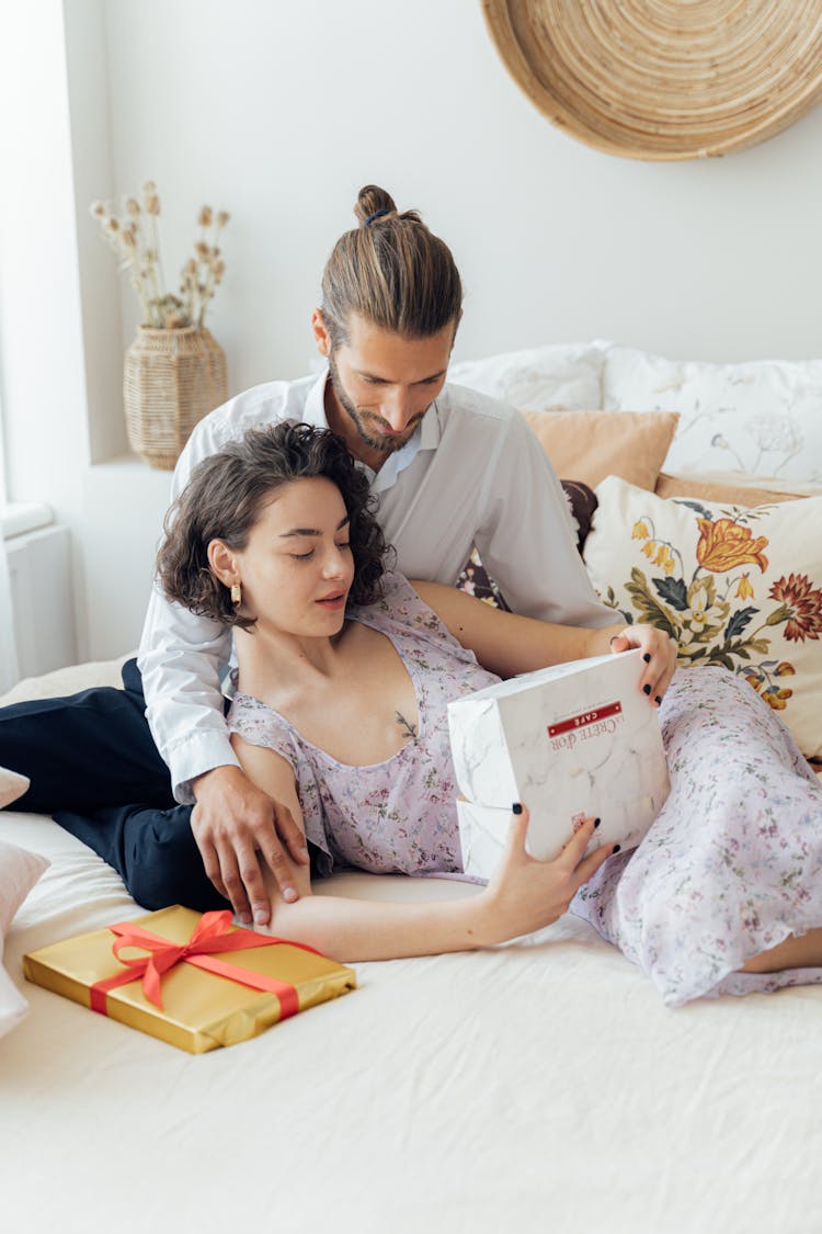 Couple Sitting On Bed