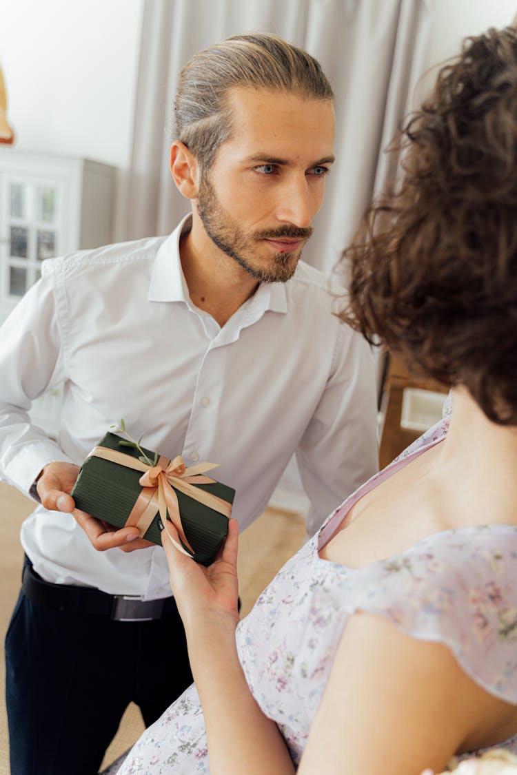 A Man Giving A Woman A Present 